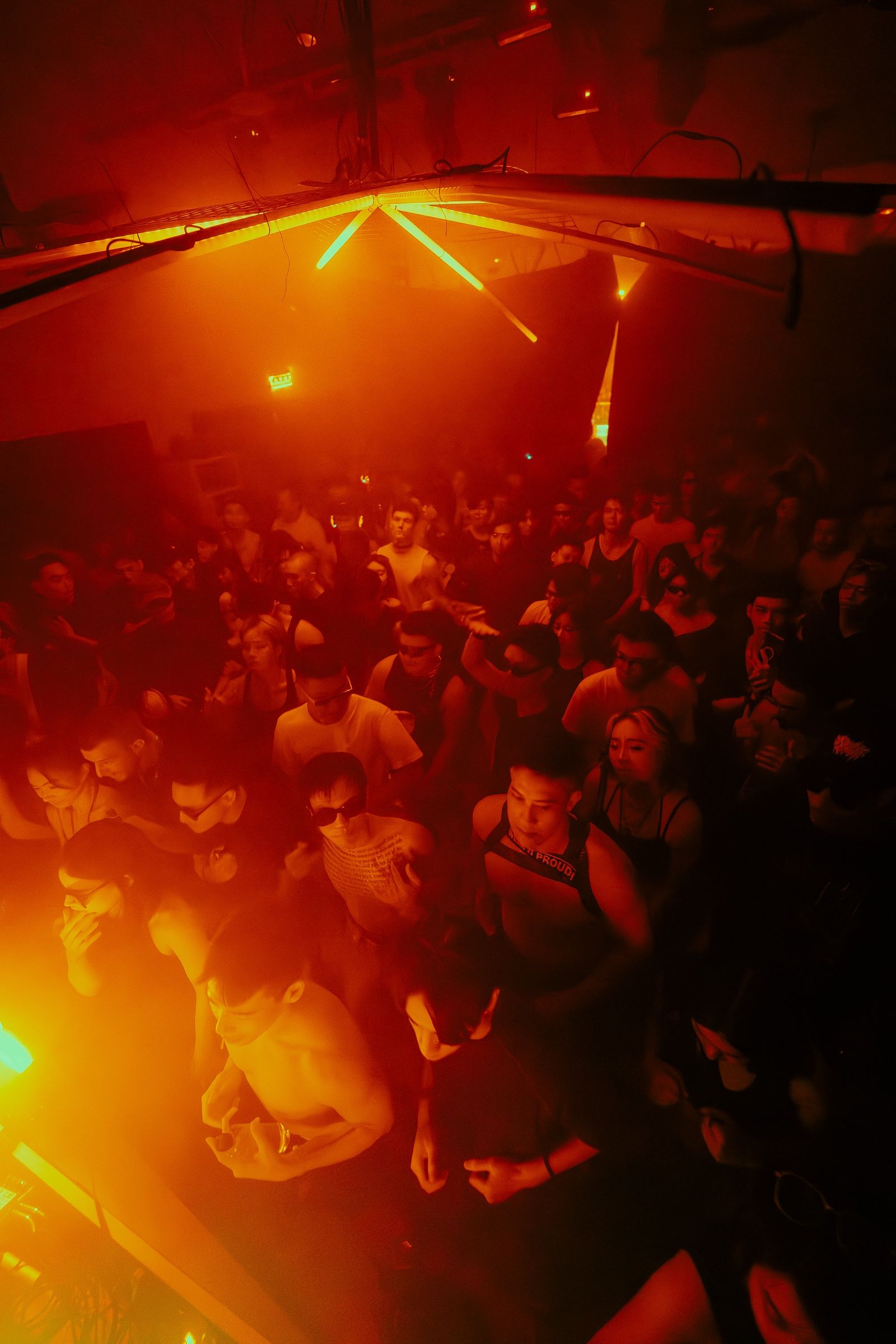 The crowd beneath amber lasers