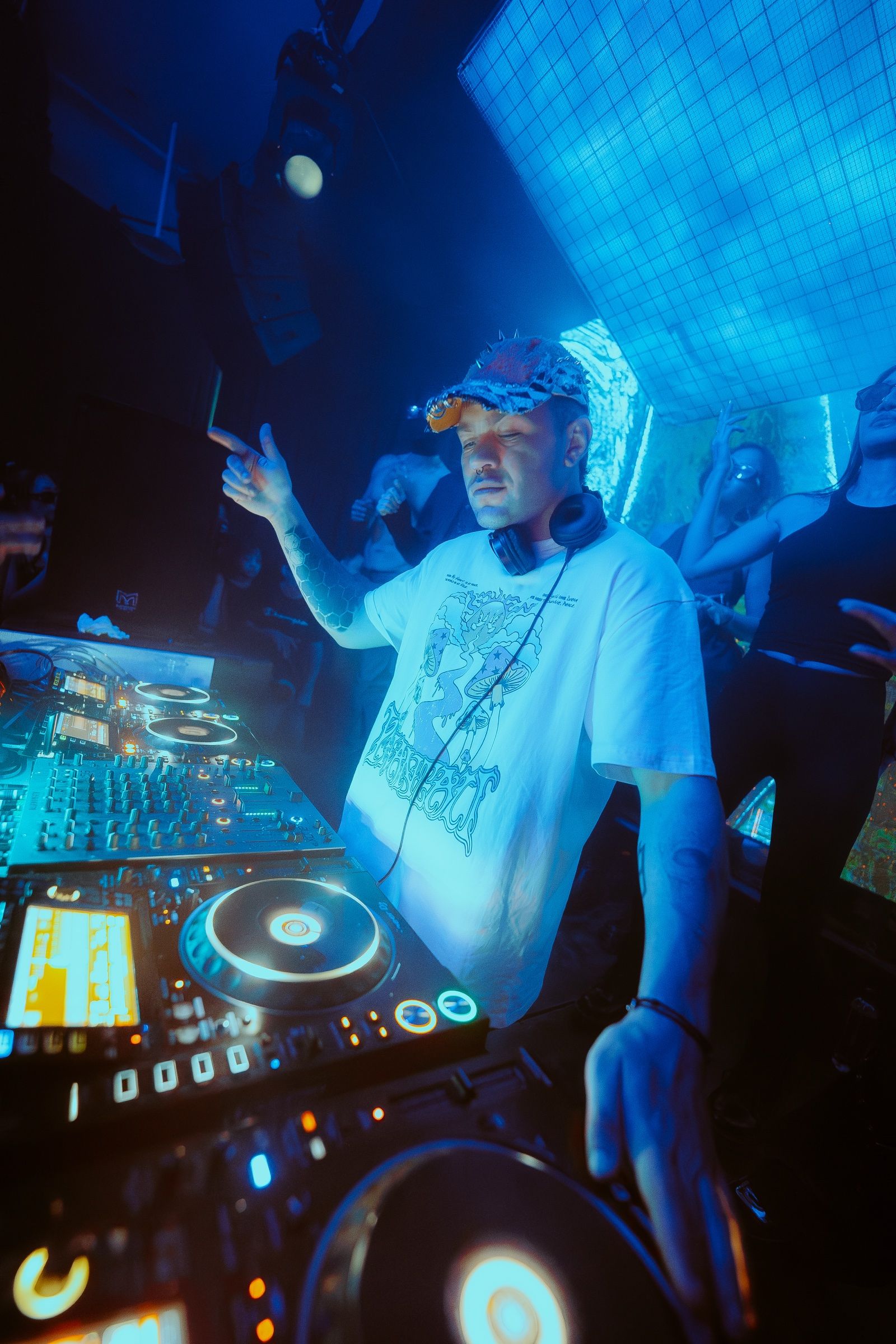 A DJ playing in blue light